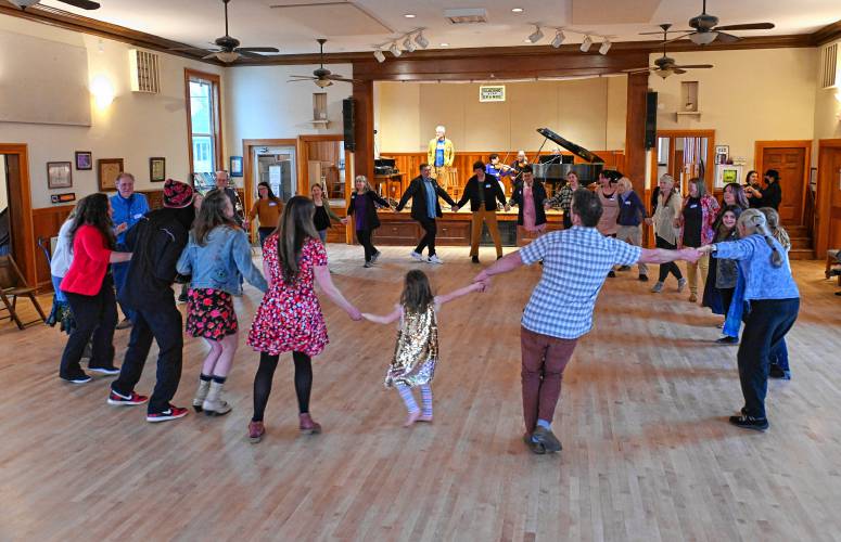 Attendees contra dance at the Guiding Star Grange in Greenfield on Thursday night during a fundraiser for the New England Learning Center for Women in Transition (NELCWIT).