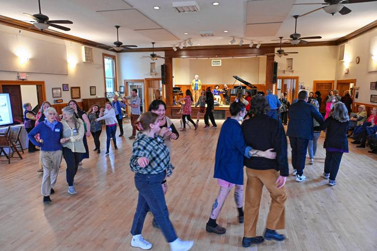 Attendees contra dance at the Guiding Star Grange in Greenfield on Thursday night during a fundraiser for the New England Learning Center for Women in Transition (NELCWIT).