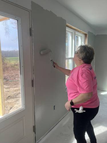 Mary Rawls of Greenfield Cooperative Bank recently volunteered to help paint a Pioneer Valley Habitat for Humanity house.
