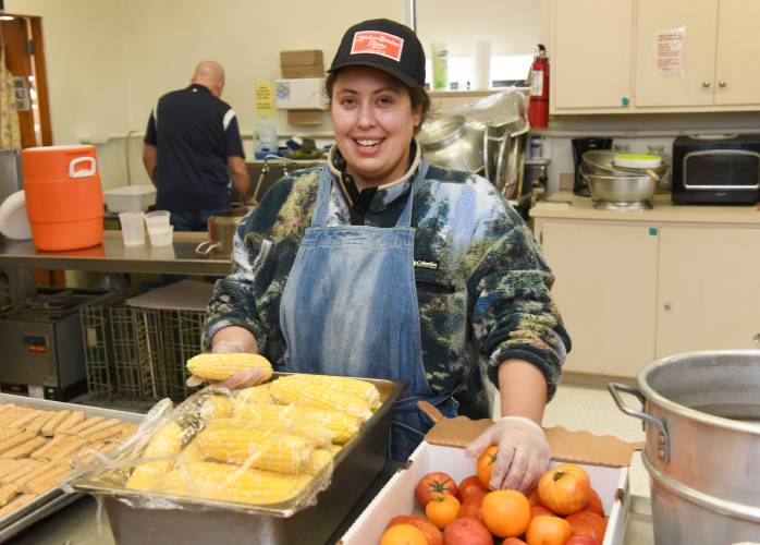 Valerie Hudson, executive director of the Franklin County Community Meals Program, works in the kitchen in the Second Congregational Church in Greenfield. The meals program will be serving to-go lunches throughout school vacation week at three locations in Greenfield and Turners Falls.