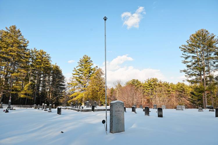 A veteran’s memorial and a flagpole in Holtshire Cemetery near Lake Mattawa in Orange.