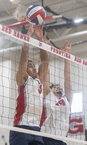 Frontier's Tavo Vincent-Warner (3) and Jonathan Olvera (19) attempt to block the ball during the volleyball game against West Springfield at Frontier High School, Tuesday, April 8, 2025, in South Deerfield.