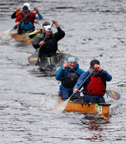 Joe Schlimmer and Frances Hiscox paddle ahead of a line of competitors during the 60th annual River Rat Race from Athol to Orange on Saturday.