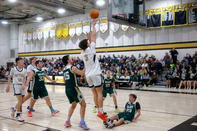 Pioneer’s Kurt Redeker (3) drives to the hoop for a layup against Ware in the first quarter of the MIAA Division 5 quarterfinal Friday night in Northfield.