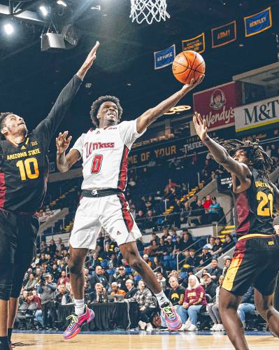 UMass sophomore guard Jaylen Curry (0) goes in for a layup during the Minutemen’s 78-62 loss to Arizona State in the Basketball Hall of Fame Classic at the MassMutual Center in Springfield on Saturday evening.
