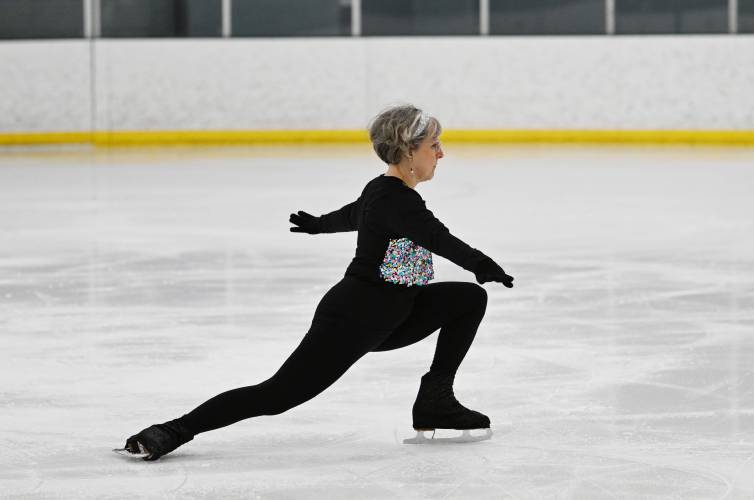 Longtime Deerfield resident Margaret Ferry, a Greenfield endocrinologist, skates to “Disco Inferno” at the ice rink at Deerfield Academy during the New England West Skating Show on Saturday. 
