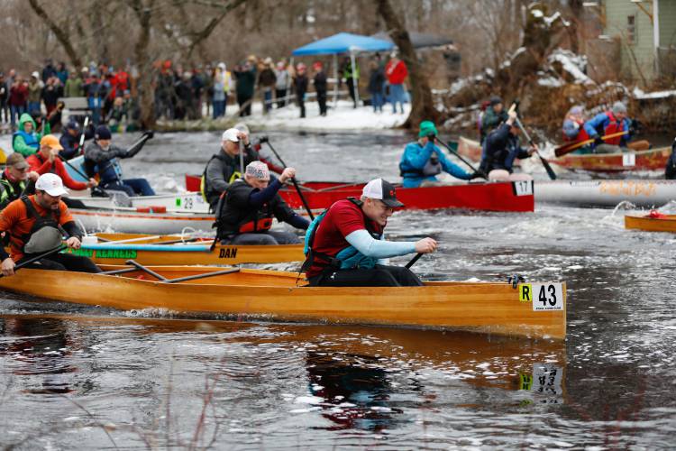 Shane McDowell and River Robertson paddle in the No. 43 boat as competitors set out at the start of the 60th annual River Rat Race from Athol to Orange on Saturday.