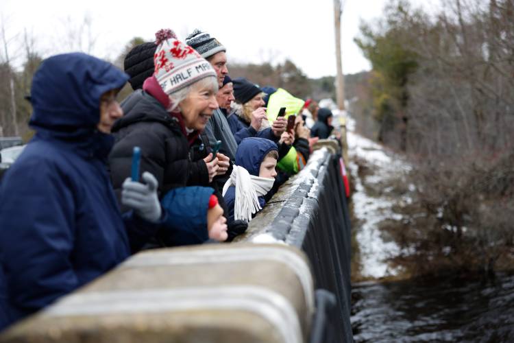 Spectators watch from the Daniel Shays Highway bridge as competitors make their way down the Millers River during the 60th annual River Rat Race from Athol to Orange on Saturday.