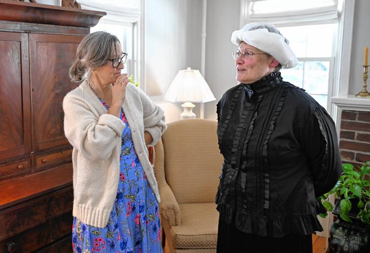 Conway resident and Mount Holyoke College student Tani Rivera talks with Mary Lyon, played by Katherine McKay, during a celebratory luncheon in Shelburne Falls to mark the birthday of the late Mary Lyon.