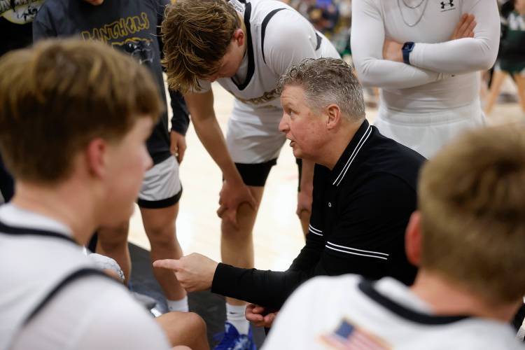 Pioneer head coach Scott Thayer talks with his team during the MIAA Division 5 quarterfinal game against Ware on Friday night in Northfield.