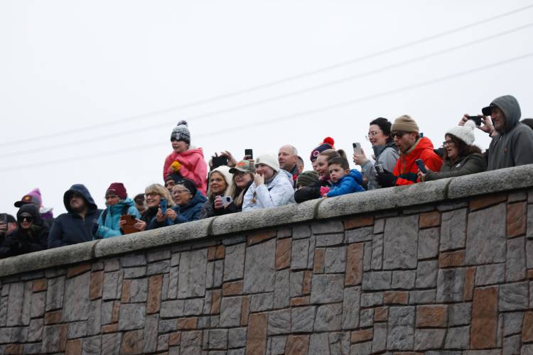 Spectators watch from the Main Street bridge at the start of the 60th annual River Rat Race from Athol to Orange on Saturday.