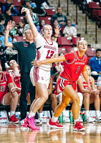 UMass guard Kasey Bretones (13) knocks down a corner 3 over Davidson’s Mallorie Haines (1) during the first half of the Minutewomen’s 56-38 loss to the Wildcats on Saturday afternoon at Mullins Center.