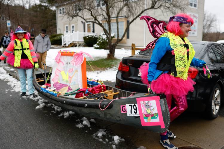 Molly Tomlinson, right, and Jocelyn Songer carry their canoe to the starting line during the 60th annual River Rat Race from Athol to Orange on Saturday.