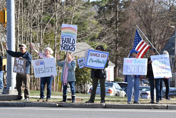 Demonstrators protest the Trump administration during weekly standouts at the intersection of Route 2 and Main Road in Gill.