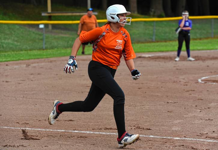 Menace’s Raine Wonsey runs toward first base after recording a hit against the Defenders during Franklin County Summer Softball League opening night action on Monday at Murphy Park in Greenfield. The eight-team league plays every Monday and Wednesday throughout the summer.