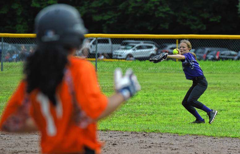 The Defenders’ Lucianne Burnap (2) throws the ball back into the infield after fielding a base hit against Menace during a Franklin County Summer Softball League contest on Monday night at Murphy Park in Greenfield.
