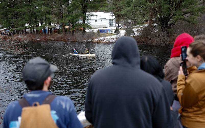 Spectators watch from the Daniel Shays Highway bridge as competitors make their way down the Millers River during the 60th annual River Rat Race from Athol to Orange on Saturday.