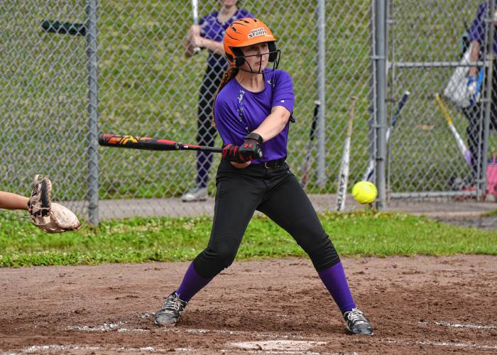 The Defenders’ Emily Kajka (12) puts the ball in play against Menace during a Franklin County Summer Softball League contest on Monday night at Murphy Park in Greenfield.