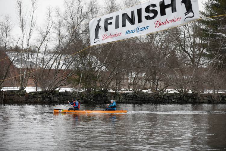 Joe Schlimmer and Frances Hiscox cross the finish line third during the 60th annual River Rat Race on Saturday in Orange.