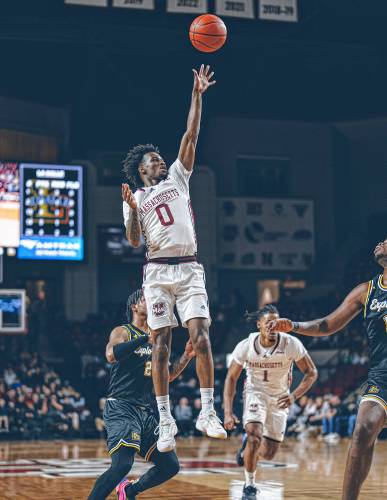 UMass guard Jaylen Curry (0) puts up a floater during the Minutemen’s 82-60 win over La Salle on Sunday night at Mullins Center in Amherst. Curry finished the night with game-highs in points (22) and assists (7).