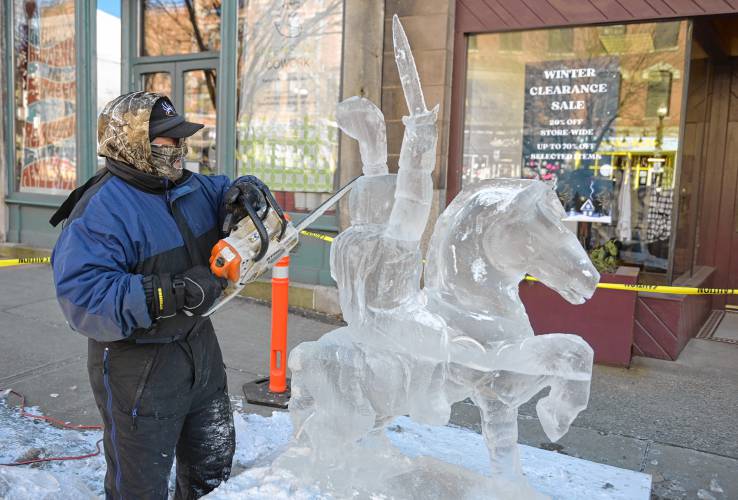 Mark Bosworth creates his ice sculpture on Main Street in Greenfield at a past Winter Carnival.