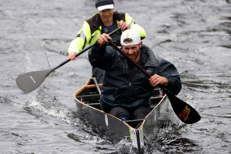 Patrick Madden, front, and Adam Gelinas paddle their way to a first place finish during the 60th annual River Rat Race from Athol to Orange on Saturday.