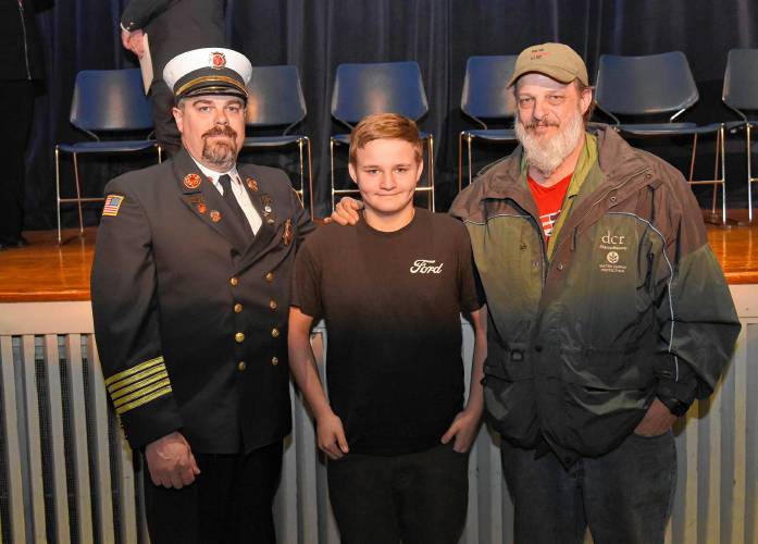 Ralph C. Mahar Regional School student Joel Wilkey, center, stands with Orange Fire Chief James Young and his grandfather Richard Wilkey, whom he awakened the night a fire broke out at their Orange home.