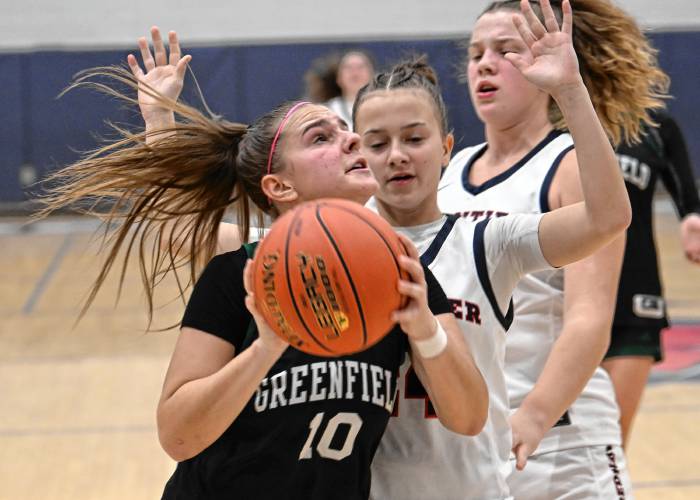 Greenfield’s Elderina Cecunjanin tries to shoot past Frontier defenders at Goodnow Gymnasium Thursday. 