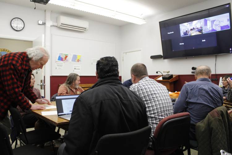 Residents sign up for public comment at a joint hearing between the Greenfield Planning Board and Economic Development Committee to discuss proposed regulations on accessory dwelling units on Tuesday.