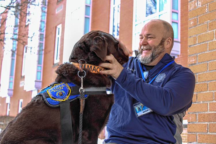 School Resource Officer Dan Miner with comfort dog Mack, pictured outside Turners Falls High School and Great Falls Middle School on Tuesday. Miner and Mack will temporarily leave the school district as Miner has been called to full-time patrol service at the Montague Police Department amid staffing shortages.