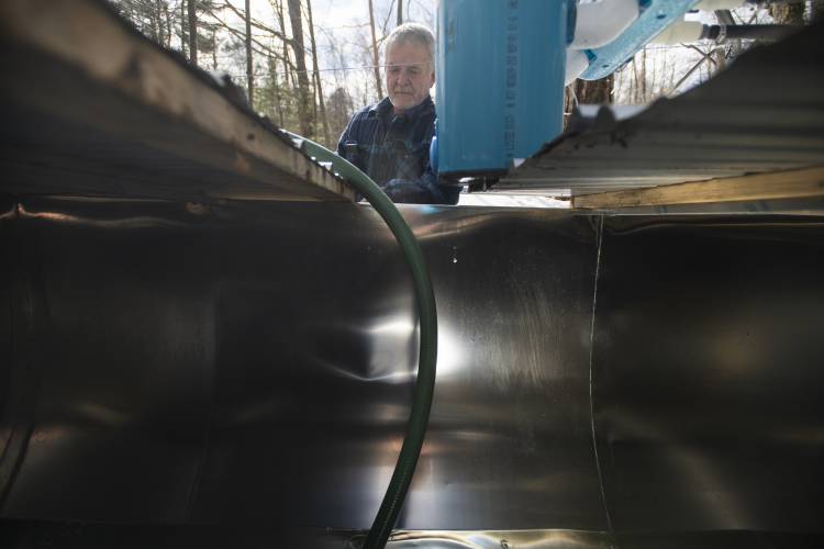 Paul’s Sugar Shack owner Paul Zononi watches as sap from a tank is pumped into another tank on a truck outside of Williamsburg on Thursday.