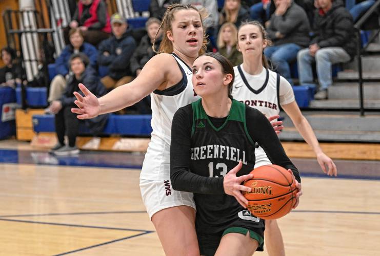Greenfield’s Tayler Bergeron drives past Frontier defenders at Goodnow Gymnasium Thursday. 