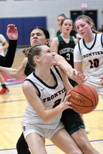 Frontier’s Abigail Schreiber is fouled by Greenfield’s Niya Strohman at Goodnow Gymnasium Thursday. 