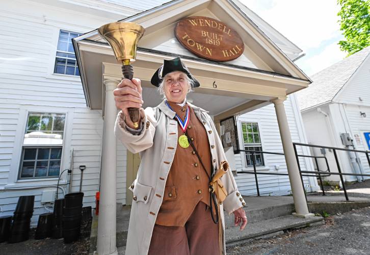 Kathy-Ann Becker, the town crier in Wendell, seen outside Town Hall.