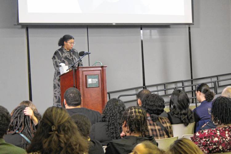 Maya Brewington reads a poem she wrote for her late mother, La Wanza Lett-Brewington, at her memorial service at Greenfield Community College on Monday.