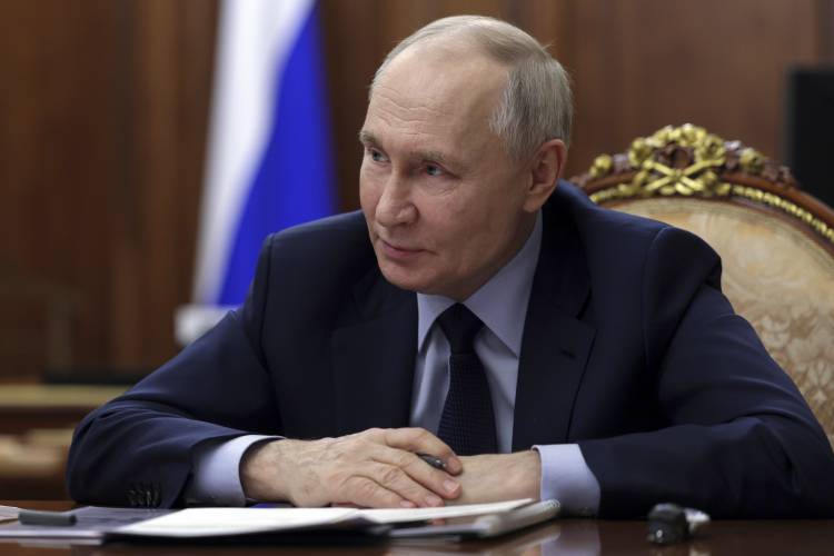 Russian President Vladimir Putin listens to acting Governor of the Kursk Region Alexander Khinshtein during their meeting at the Kremlin in Moscow, Russia, Wednesday.