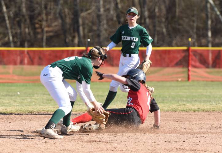 Hampshire Regional’s Lucy Trombley, right, slides into second safely as Greenfield’s Anna Bucala, left, applies a tag during the Radiers’ 4-0 win over the Green Wave on Monday afternoon in Westhampton.