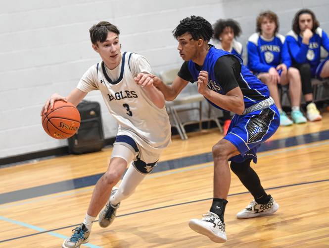 Franklin Tech’s Gabe Mota, left, drives past Turners Falls’ Alex Quezada during the visiting Thunder’s 55-35 Hampshire League North victory on Tuesday night in Turners Falls.