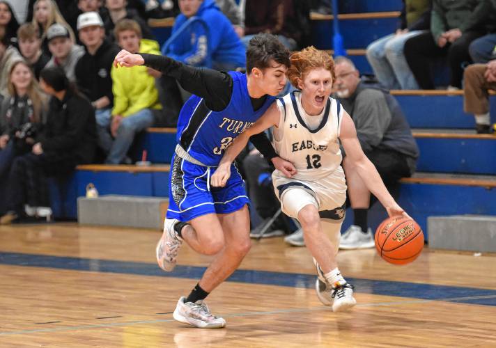 Franklin Tech’s Josiah Little is defended by Turners Falls’ Dylen Richardson during the visiting Thunder’s 55-35 Hampshire League North victory on Tuesday night in Turners Falls.