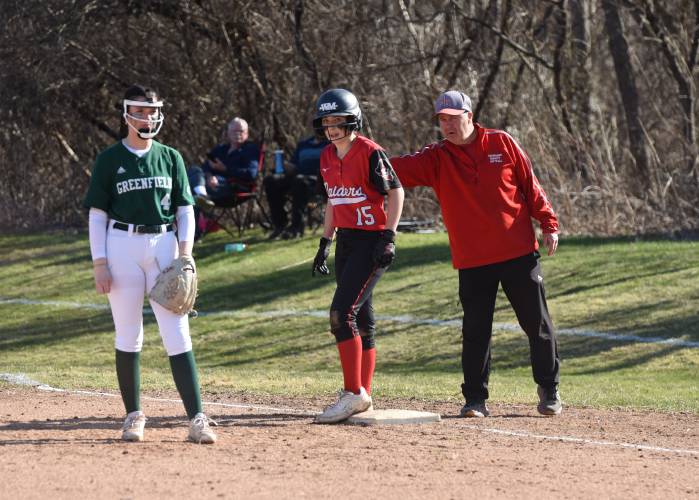 Hampshire Regional’s Lucy Trombley (15) receives instruction from the Raiders’ first-base coach during Hampshire’s 4-0 win over Greenfield on Monday afternoon in Westhampton.