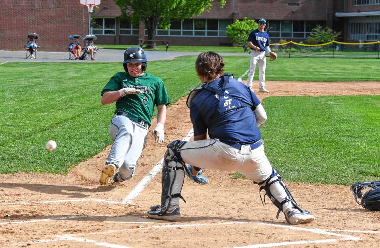 Greenfield’s John Marchefka scores before the ball reaches  Frontiers catcher Kaden James in South  Deerfield on Thursday. 