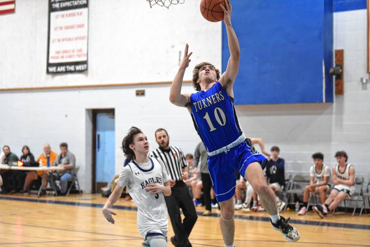 Turners Falls’ Cam Burnett goes up for a layup trailed by Franklin Tech’s Gabe Mota during the visiting Thunder’s 55-35 Hampshire League North victory on Tuesday night in Turners Falls.