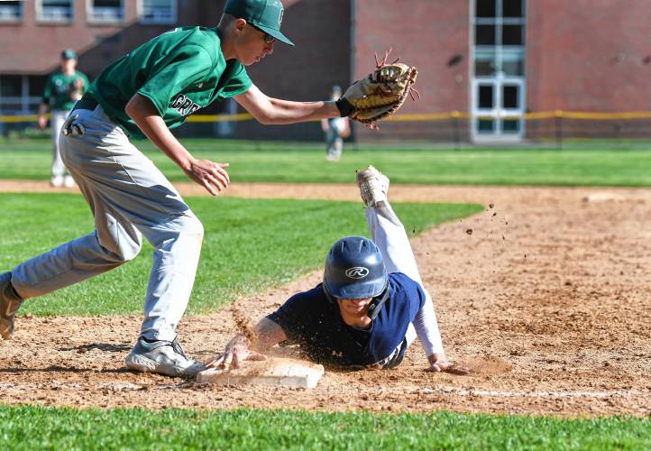 Frontier’s Nico Fasulo dives back to first ahead of the tag from Greenfield’s Nick Prasol in South Deerfield on Thursday. 