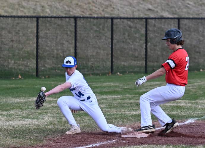 Turners Falls’ Nathaniel Trinque misses the throw from home to third as Athol base runner Hayden Barrieau then proceeded home in Montague on Tuesday. 