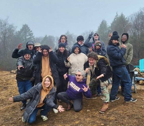 Mary Canning, front and center, an Emerson College alumna and the owner of Salamander Hollow Healing Habitat in Warwick, hosted about a dozen Emerson students and two professional actors who were working on “The Bigfake,” a short film about a lonely retired park ranger who fabricates a Bigfoot sighting to draw people to his secluded cabin.