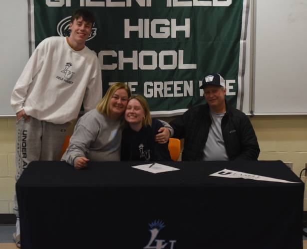 Riley Thayer with her brother Brayden Thayer, mom Erin Thayer and dad Scott Thayer after signing her National Letter of Intent to play field hockey at Lasell University on Thursday at Greenfield High School. 