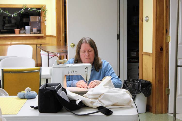 Hilma Sumner sews a quilt for hurricane victims in North Carolina on Friday at Heath Union Church.