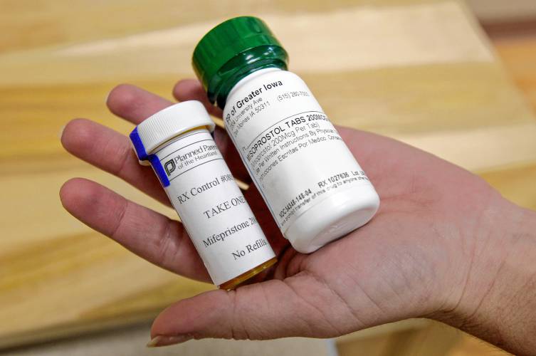 FILE - Bottles of abortion pills mifepristone, left, and misoprostol, right, are displayed at a clinic in Des Moines, Iowa, Sept. 22, 2010. (AP Photo/Charlie Neibergall, File)
