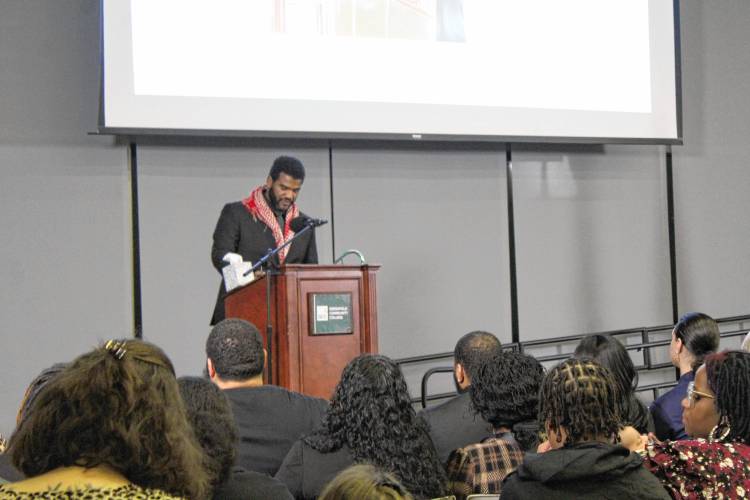 Danton Brewington delivers a eulogy for his late mother, La Wanza Lett-Brewington, at her memorial service at Greenfield Community College on Monday.