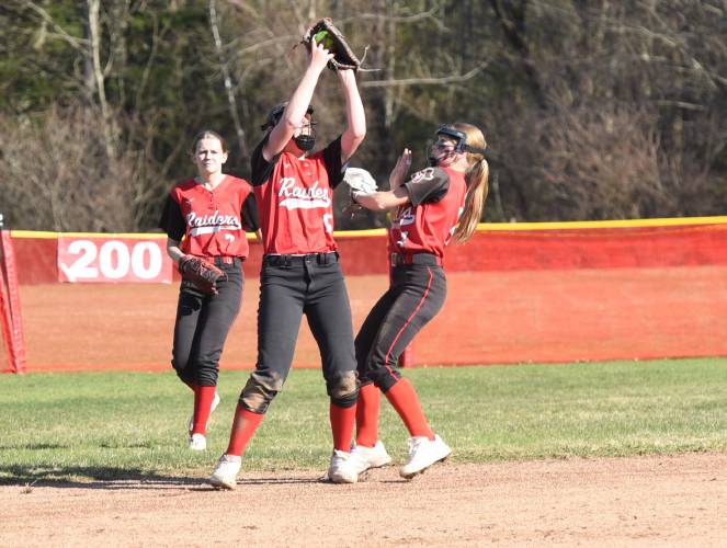 Hampshire Regional’s Lucy Trombley catches a pop fly at shortstop with her teammates around her during the Radiers’ 4-0 win over Greenfield on Monday afternoon in Westhampton.